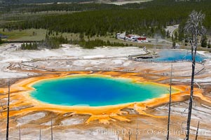 Grand Prismatic Spring (left) and Excelsior Geyser (right).  Grand Prismatic Spring displays a stunning rainbow of colors created by species of thermophilac (heat-loving) bacteria that thrive in narrow temperature ranges.  The blue water in the center is too hot to support any bacterial life, while the outer orange rings are the coolest water.  Grand Prismatic Spring is the largest spring in the United States and the third-largest in the world.  Midway Geyser Basin, Yellowstone National Park, Wyoming