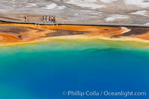 Grand Prismatic Spring displays a stunning rainbow of colors created by species of thermophilac (heat-loving) bacteria that thrive in narrow temperature ranges.  The blue water in the center is too hot to support any bacterial life, while the outer orange rings are the coolest water.  Grand Prismatic Spring is the largest spring in the United States and the third-largest in the world.  Midway Geyser Basin, Yellowstone National Park, Wyoming