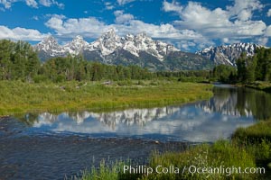 The Grand Tetons, reflected in the glassy waters of the Snake River at Schwabacher Landing, on a beautiful summer morning, Grand Teton National Park, Wyoming