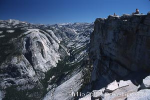 Hikers atop Summit of Half Dome, view of Tenaya Canyon, Yosemite National Park, California