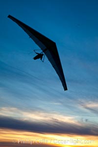 Hang Glider soaring at Torrey Pines Gliderport, sunset, flying over the Pacific Ocean, La Jolla, California