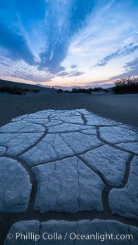 Hardened mud playa and sand dunes, dawn, Mesquite dunes, Stovepipe Wells, Death Valley National Park, California