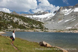 Hiker admires Townsley Lake (10396') and the Cathedral Range in Yosemite's High Sierra, Yosemite National Park, California