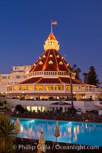 Hotel del Coronado with holiday Christmas night lights, known affectionately as the Hotel Del. It was once the largest hotel in the world, and is one of the few remaining wooden Victorian beach resorts. It sits on the beach on Coronado Island, seen here with downtown San Diego in the distance. It is widely considered to be one of Americas most beautiful and classic hotels. Built in 1888, it was designated a National Historic Landmark in 1977