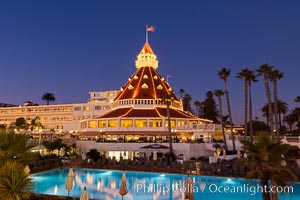 Hotel del Coronado with holiday Christmas night lights, known affectionately as the Hotel Del. It was once the largest hotel in the world, and is one of the few remaining wooden Victorian beach resorts. It sits on the beach on Coronado Island, seen here with downtown San Diego in the distance. It is widely considered to be one of Americas most beautiful and classic hotels. Built in 1888, it was designated a National Historic Landmark in 1977