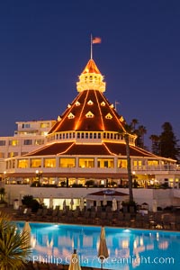 Hotel del Coronado with holiday Christmas night lights, known affectionately as the Hotel Del. It was once the largest hotel in the world, and is one of the few remaining wooden Victorian beach resorts. It sits on the beach on Coronado Island, seen here with downtown San Diego in the distance. It is widely considered to be one of Americas most beautiful and classic hotels. Built in 1888, it was designated a National Historic Landmark in 1977