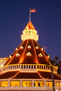 Hotel del Coronado with holiday Christmas night lights, known affectionately as the Hotel Del. It was once the largest hotel in the world, and is one of the few remaining wooden Victorian beach resorts. It sits on the beach on Coronado Island, seen here with downtown San Diego in the distance. It is widely considered to be one of Americas most beautiful and classic hotels. Built in 1888, it was designated a National Historic Landmark in 1977