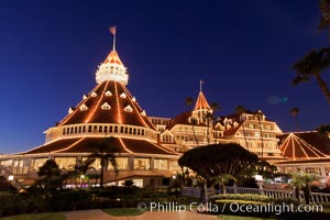 Hotel del Coronado with holiday Christmas night lights, known affectionately as the Hotel Del. It was once the largest hotel in the world, and is one of the few remaining wooden Victorian beach resorts. It sits on the beach on Coronado Island, seen here with downtown San Diego in the distance. It is widely considered to be one of Americas most beautiful and classic hotels. Built in 1888, it was designated a National Historic Landmark in 1977