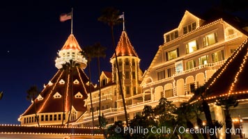 Hotel del Coronado with holiday Christmas night lights, known affectionately as the Hotel Del. It was once the largest hotel in the world, and is one of the few remaining wooden Victorian beach resorts. It sits on the beach on Coronado Island, seen here with downtown San Diego in the distance. It is widely considered to be one of Americas most beautiful and classic hotels. Built in 1888, it was designated a National Historic Landmark in 1977