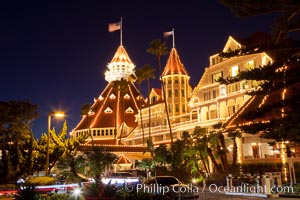 Hotel del Coronado with holiday Christmas night lights, known affectionately as the Hotel Del. It was once the largest hotel in the world, and is one of the few remaining wooden Victorian beach resorts. It sits on the beach on Coronado Island, seen here with downtown San Diego in the distance. It is widely considered to be one of Americas most beautiful and classic hotels. Built in 1888, it was designated a National Historic Landmark in 1977.