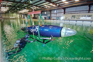 The OMER 5 human-powered submarine is raised from the Offshore Model Basin in Escondido California.  The sub was designed, built and operated by Montreal, Canadas École de Technologie Supérieure (University of Quebec) engineering students.  The submersible is 16 feet long and has two people inside powering and piloting the sub.  Made of high tech composite materials and containing networked computers, the OMER 5 has reached a speed of nearly 7 knots underwater, a world record for human-powered submarines