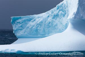 Iceberg, ocean, light and clouds.  Light plays over icebergs and the ocean near Coronation Island.