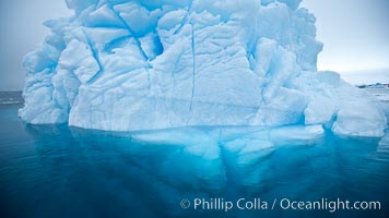 Iceberg above water and some of the underwater portion seen as well.