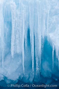 Icicles and melting ice, hanging from the edge of an blue iceberg.  Is this the result of climate change and global warming?, Brown Bluff