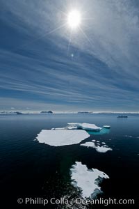 Ice, ocean, clouds and sun, Antarctica.