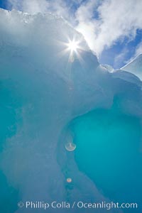 Sun peeks through a hole in ice along the shore of Paulet Island. Antarctic Peninsula, Antarctica, natural history stock photograph, photo id 24832