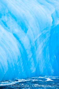 A blue iceberg.  Blue icebergs are blue because the ice from which they are formed has been compressed under such enormous pressure that all gas (bubbles) have been squeezed out, leaving only solid water that takes on a deep blue color.