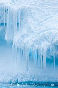 Icicles and melting ice, hanging from the edge of an blue iceberg.  Is this the result of climate change and global warming?, Brown Bluff