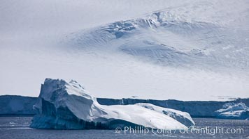 Iceberg and snow-covered coastline, Antarctic Sound.