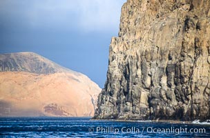 El Moro, a huge volcanic headland at the south end of Guadalupe Island, is seen here partially obscuring the more distant Isla Adentro.  Daybreak, Guadalupe Island (Isla Guadalupe)