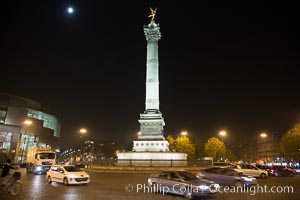 July Column in the Place de la Bastille. The Place de la Bastille is a square in Paris, where the Bastille prison stood until the 'Storming of the Bastille' and its subsequent physical destruction between 14 July 1789 and 14 July 1790 during the French Revolution. The square straddles 3 arrondissements of Paris, namely the 4th, 11th and 12th. The July Column (Colonne de Juillet) which commemorates the events of the July Revolution (1830) stands at the center of the square