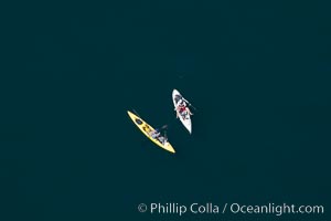 Kayak fishermen sitting still on the open ocean