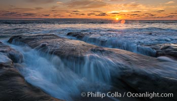 La Jolla coast sunset, waves wash over sandstone reef, clouds and sky