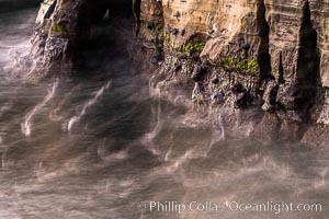 Sea Caves, the famous La Jolla sea caves lie below tall cliffs at Goldfish Point.  Sunny Jim Cave. Sunrise. Sea gulls floating int he water blur in this time exposure.