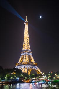 River Seine, Full Moon and Eiffel Tower at night, Paris. La Tour Eiffel. The Eiffel Tower is an iron lattice tower located on the Champ de Mars in Paris, named after the engineer Gustave Eiffel, who designed the tower in 1889 as the entrance arch to the 1889 World's Fair. The Eiffel tower is the tallest structure in Paris and the most-visited paid monument in the world