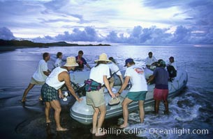 Land visit and sunset, skiff and tourists, Floreana Island