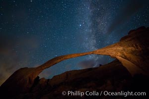 Landscape Arch and Milky Way, stars rise over the arch at night.