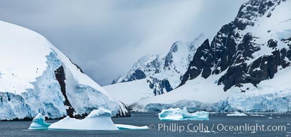 Lemaire Channel: mountains, sea, ice and clouds,Antarctica.  The Lemaire Channel, one of the most scenic places on the Antarctic Peninsula, is a straight 11 km long and only 1.6 km wide at its narrowest point