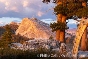 Lembert Dome and late afternoon clouds rise above Tuolumne Meadows in the High Sierra, catching the fading light of sunset, Yosemite National Park, California