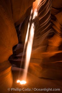 Light Beam in Upper Antelope Slot Canyon.  Thin shafts of light briefly penetrate the convoluted narrows of Upper Antelope Slot Canyon, sending piercing beams through the sandstone maze to the sand floor below.