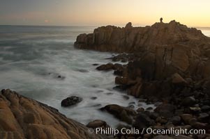 Lovers Point, Pacific Grove.  A couple admires the sunrise atop Lovers Point in Pacific Grove.  Waves breaking over rocks appear as a foggy mist in this time exposure.  Pacific Grove