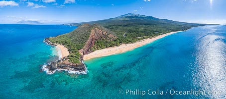 Makena Beach State Park aerial photo, Maui, Hawaii. Big Beach on the right, Little Beach on the left, Haleakala rising in the distance on the right, West Maui Mountains in the distance on the left.