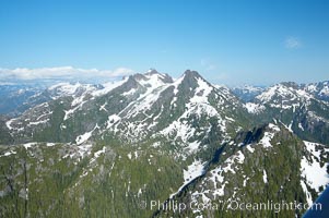Image 21071, Mariner Mountain, viewed from the northwest, on the west coast of Vancouver Island, British Columbia, Canada, part of Strathcona Provincial Park, located 36 km (22 mi) north of Tofino.  It is 1,771 m (5,810 ft) high, snow covered year-round and home to several glaciers., Phillip Colla, all rights reserved worldwide. Keywords: aerial, aerial photo, british columbia, canada, landscape, marine, mariner mountain, nature, ocean, outdoors, outside, provincial parks, scene, scenic, strathcona provincial park, threatened, tofino, vancouver island.