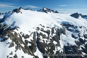 Image 21120, Glaciers on the summit of Mariner Mountain, on the west coast of Vancouver Island, British Columbia, Canada, part of Strathcona Provincial Park, located 36 km (22 mi) north of Tofino.  It is 1,771 m (5,810 ft) high and is snow covered year-round., Phillip Colla, all rights reserved worldwide. Keywords: aerial, aerial photo, british columbia, canada, landscape, marine, mariner mountain, nature, ocean, outdoors, outside, provincial parks, scene, scenic, strathcona provincial park, threatened, tofino, vancouver island.