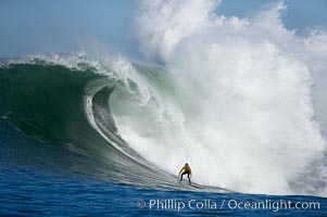 2006 Mavericks surf contest champion Grant Twiggy Baker of South Africa catches one of his many great waves of the day, this one in the first round.  Check out the huge bounce lifting up behind him, heavy.  Mavericks surf contest, February 7, 2006, Half Moon Bay, California