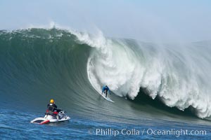 Grant Washburn (fifth place) gives the jetski photographer a show in the early rounds of the Mavericks surf contest, February 7, 2006, Half Moon Bay, California
