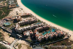 Aerial view of Medano Beach in Cabo San Lucas, showing many resorts along the long white sand beach