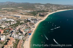 Aerial view of Medano Beach in Cabo San Lucas, showing many resorts along the long white sand beach