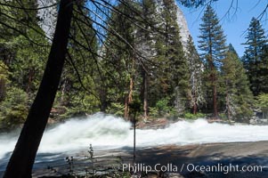 Merced River rapids at peak flow in late spring crashes through woods above Vernal Falls, Yosemite National Park, California