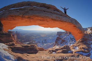 Extended High Mountain pose, Utthita Tadasana, at dawn on Mesa Arch, Utah.  An exuberant hiker greets the dawning sun from atop Mesa Arch, Island in the Sky, Canyonlands National Park