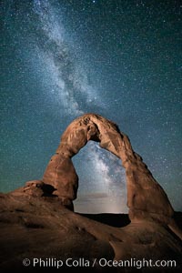 Milky Way arches over Delicate Arch, as stars cover the night sky. (Note: this image was created before a ban on light-painting in Arches National Park was put into effect.  Light-painting is no longer permitted in Arches National Park)