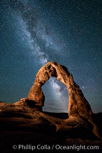 Milky Way arches over Delicate Arch, as stars cover the night sky. (Note: this image was created before a ban on light-painting in Arches National Park was put into effect.  Light-painting is no longer permitted in Arches National Park)