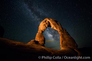 Milky Way arches over Delicate Arch, as stars cover the night sky. (Note: this image was created before a ban on light-painting in Arches National Park was put into effect.  Light-painting is no longer permitted in Arches National Park)