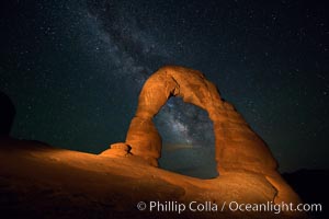 Milky Way arches over Delicate Arch, as stars cover the night sky. (Note: this image was created before a ban on light-painting in Arches National Park was put into effect.  Light-painting is no longer permitted in Arches National Park)