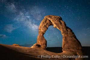 Milky Way arches over Delicate Arch, as stars cover the night sky. (Note: this image was created before a ban on light-painting in Arches National Park was put into effect.  Light-painting is no longer permitted in Arches National Park)