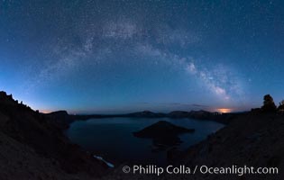 Milky Way and stars over Crater Lake at night. Panorama of Crater Lake and Wizard Island at night, Crater Lake National Park